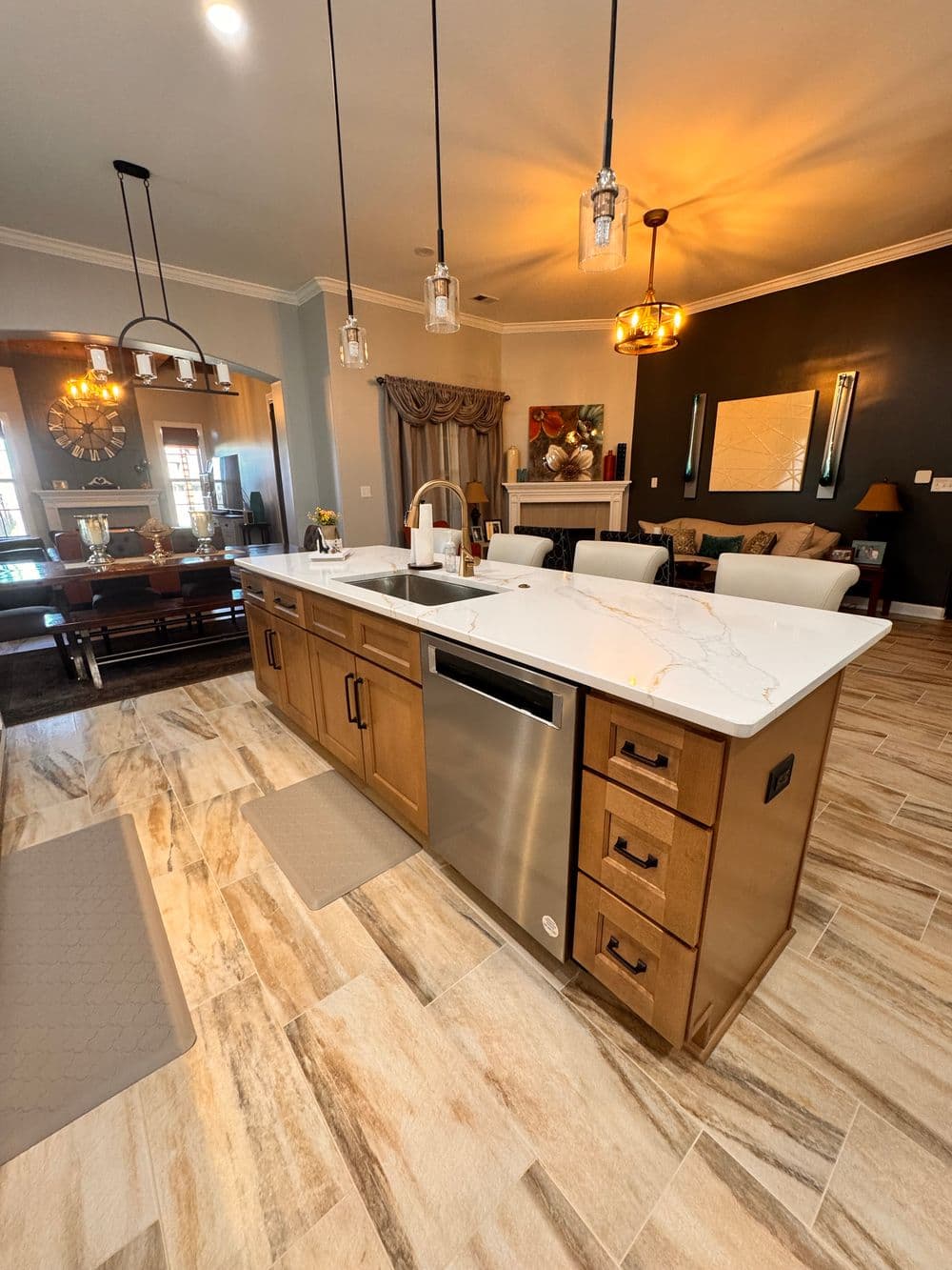 Modern kitchen with quartz countertop island, stainless steel appliances, and stylish decor.